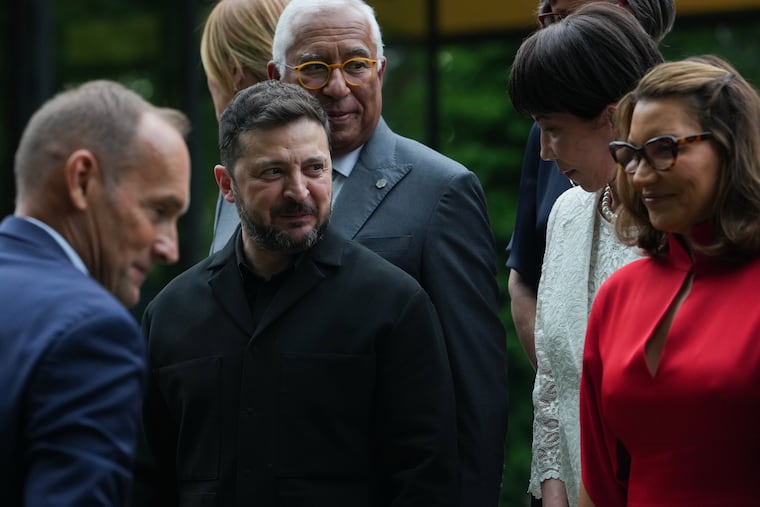 European Council President Antonio Costa, Ukrainian President Volodymyr Zelensky, Japan's Prime Minister Sanae Takaichi and others gather for a group photo at the G7 summit Tuesday in Evian-les-Bains, France.
