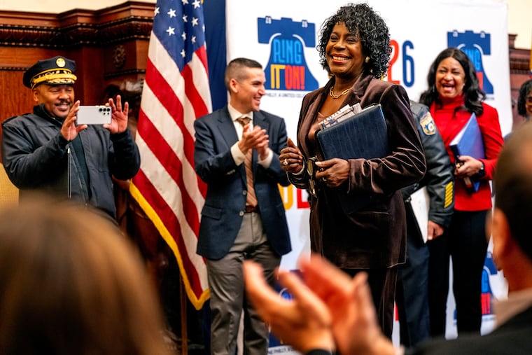 Fire Commissioner Jeffrey Thompson (left) records Mayor Cherelle L. Parker as she dances a (modified) mayoral Mummers strut to the music of the Quaker City String Bang following Monday's news conference at City Hall. City officials shared details on how Philadelphians and visitors can ring in the new year and celebrate the official kickoff of the nation’s 250th anniversary, including the first-ever New Year’s Eve concert and fireworks on the Benjamin Franklin Parkway. Behind her are Dominick Mireles (left) deputy managing director, community safety; and Jazelle Jones (right), city representative and director of special events