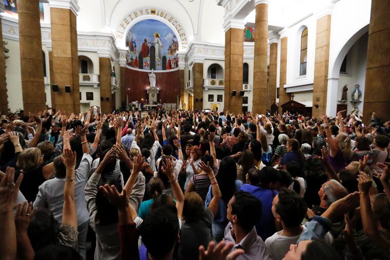 People greet Venezuelan Congress President Juan Guaido during the Ash Wednesday Mass celebrations in Caracas, Venezuela, Wednesday, March 6, 2019. The U.S. and more than 50 governments recognize Guaido as interim president, saying President Nicolas Maduro wasn't legitimately re-elected last year because opposition candidates weren't permitted to run. (AP Photo/Eduardo Verdugo)