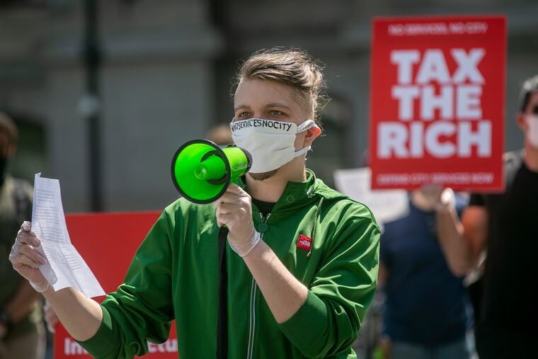 Flan Park, After School Leader at South Philly Library, speaks during the rally held by city workers at Dilworth Plaza on Tuesday, asking Mayor Jim Kenney to tax the rich instead of cutting city services and laying off workers.