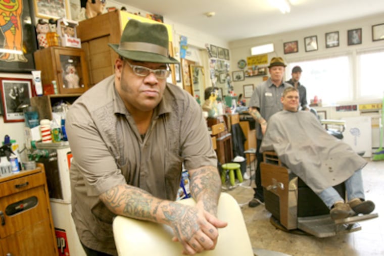 John Scioli in his John's Old School New Skool Barber Shop in Schwenksville. (Charles Fox / Staff Photographer)