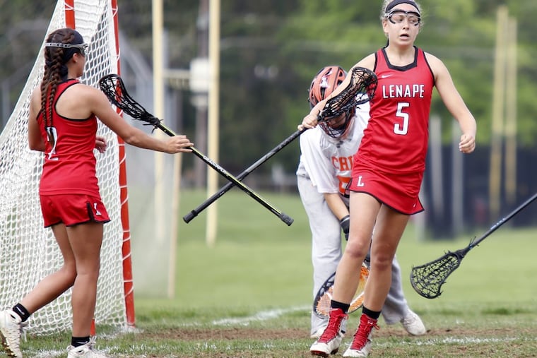 Lenape teammates Lauren Figura (5) and Gabrielle Fornia tap sticks in celebration of Figura’s goal last season.