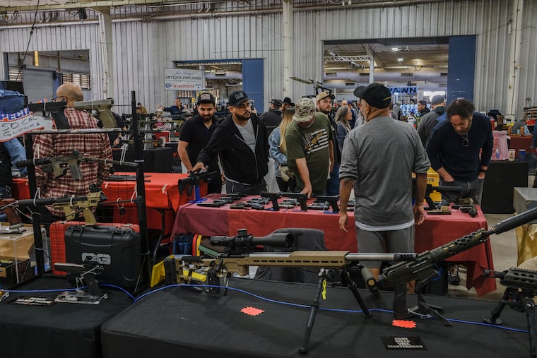People shop for weapons at the Crossroads of the West Gun Show at the Arizona State Fairgrounds in Phoenix, on Sunday, Jan. 18, 2026. Critics say the administration is weakening public safety. Proponents say regulations would be where they were before President Joseph R. Biden took office.