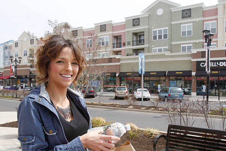Alyssa Caloiero brings back her lunch from Burger 21 in the Voorhees Town Center. She sold her car before moving in last October, and she works and teaches in a beauty school there.
