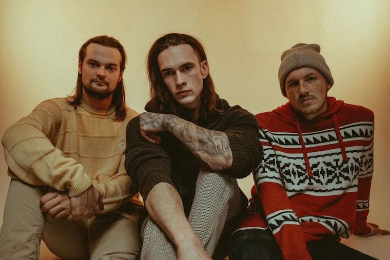 Jonathan Gerlach, center, is accused of stealing human remains from Mount Moriah Cemetery. Blake McClimon, left, was in a metalcore band with Gerlach.