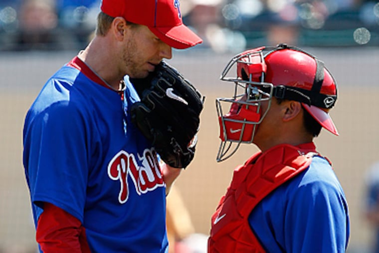 Philadelphia Phillies pitcher Roy Halladay, left, talks with catcher Carlos Ruiz during the second inning. (AP Photo/Gene J. Puskar)