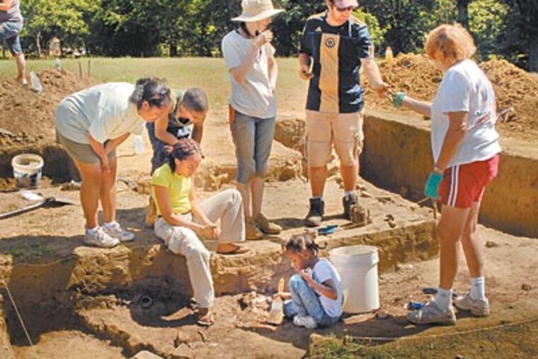 Christopher Barton (second from right), site manager and Temple University archaeological doctoral student, working with staff and volunteers at the Timbuctoo historical excavation in Westampton on Wednesday. (TOM GRALISH / Staff Photographer)