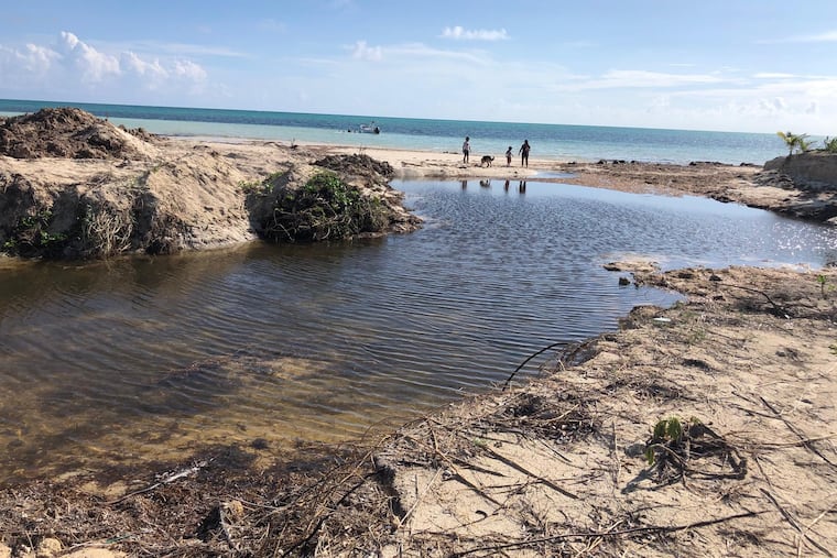 Hurricane Dorian carved an inlet into Fortune Beach on Grand Bahama Island, with a storm surge that traversed the island from the north.
