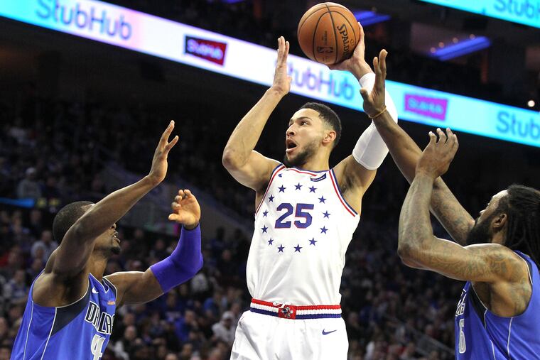 Ben Simmons, center, of the Sixers shoots over Harrison Barnes, left, and DeAndre Jordan of the Mavericks on Jan. 5, 2019.