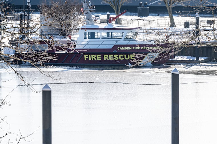 A fire rescue boat is docked along the icy waters of the Delaware River at the Camden waterfront on Thursday after a firefighter died earlier in the day when he fell into the river.