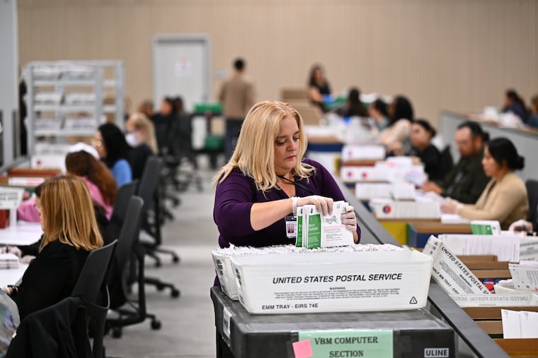 A worker sorts ballots at the L.A. County Ballot Processing Center during the California primary election in June in City of Industry, Calif.