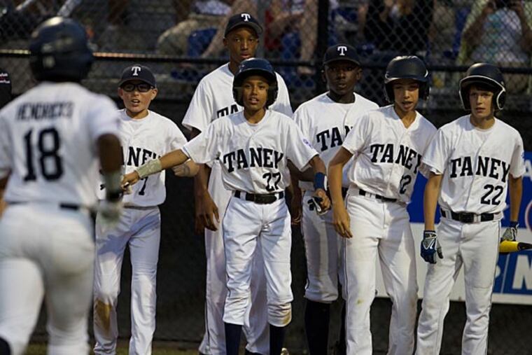 Jahli Hendricks (18) is congratulated at home plate. (Photo by David Butler II)