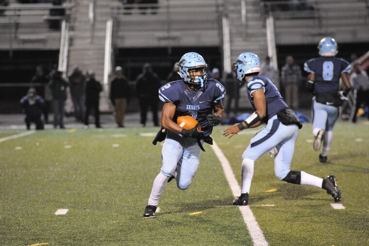 North Penn running back Solomon Robinson hands off to Jon Haynes in last week's semifinal matchup between North Penn and Downingtown West.