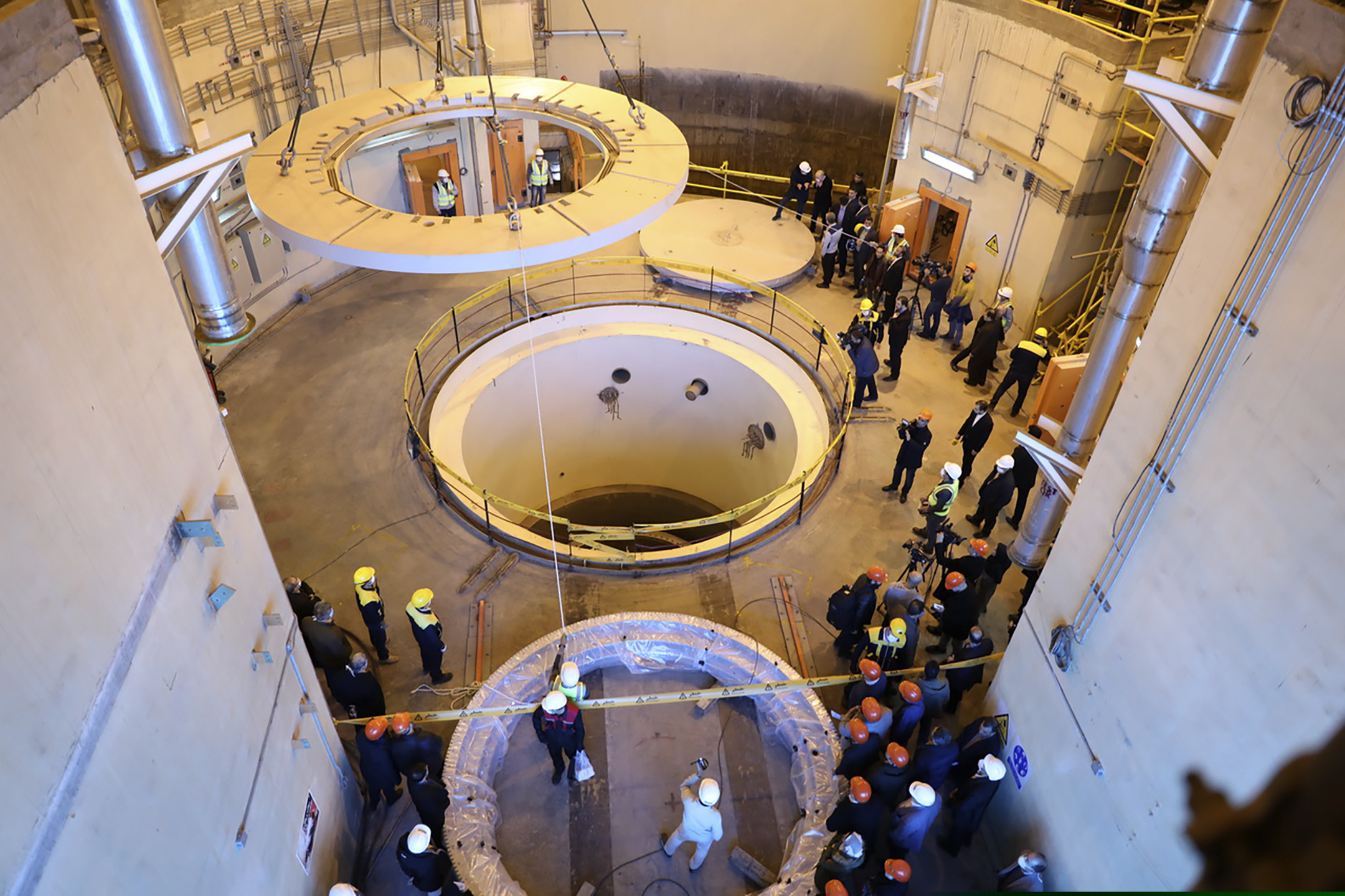 Technicians work at the Arak heavy water reactor's secondary circuit, as officials and media visit the site, near Arak, Iran.