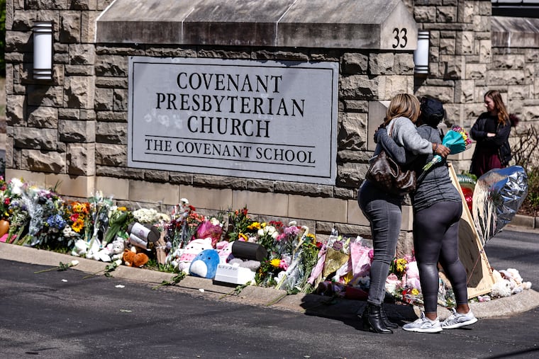 Two women hug at a memorial at the entrance to The Covenant School in Nashville, Tenn., last month. Six people, including three children, were killed in a shooting at the school on March 27.