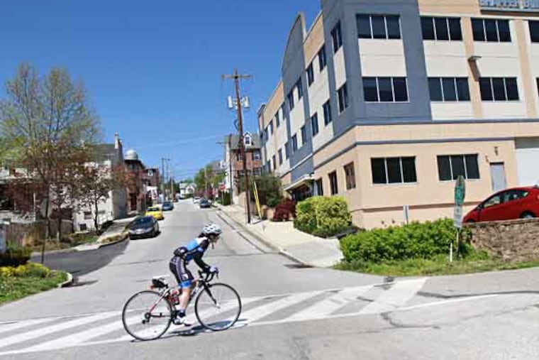 A bicyclist heads east along the bike trail in Conshohocken April 25, 2013. ( DAVID SWANSON / Staff Photographer )