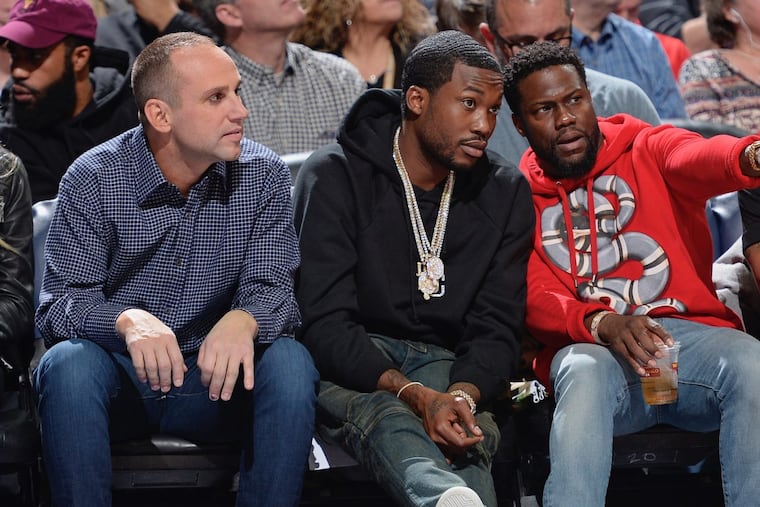 Meek Mill (center) with Kevin Hart and minority 76ers owner Michael Rubin at a game last season.