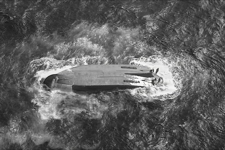 A U.S. Coast Guard HC-130 Hercules airplane crew assigned to Coast Guard Air Station Barbers Point flies over an overturned vessel offshore Saipan, Saturday, April 18, 2026, while searching for a missing vessel, the Mariana, that experienced an engine failure April 15.