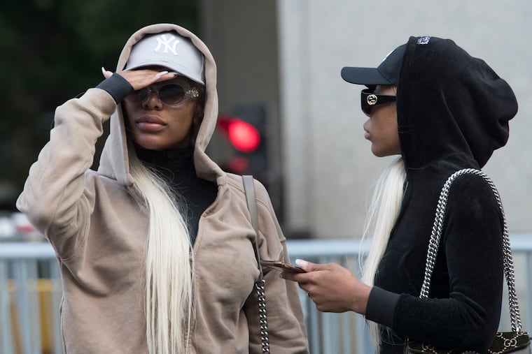 FILE - This July 11, 2018, file photo shows Shannade Clermont (left) and her twin sister Shannon outside of federal court in New York after her arraignment on charges she stole debit card information from a man who died from a drug overdose in his Manhattan apartment the morning after hiring her as a prostitute in 2017. Shannade Clermont was sentenced to a year in prison on Thursday, April 4, 2019.