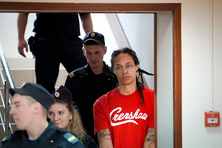 WNBA star and two-time Olympic gold medalist Brittney Griner (right) being escorted to a courtroom for a hearing in Khimki, outside Moscow, on July 7.