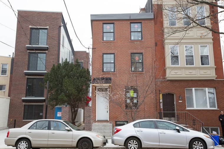 The exterior of a trinity home, center, located on the 1000 block of Moyamensing Ave., in Philadelphia.