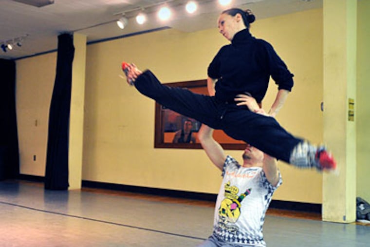 Melissa Rector, top, and Micah Geyer rehearse a lift for an upcoming performance of Koresh Dance Company. Rector, the company's assistant artistic director, has been with the company since its beginning. (Sharon Gekoski-Kimmel/ Staff Photographer)