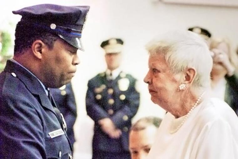 DAILY NEWS FILE PHOTO: Officer Andre Boyer, who shared a moment with the sister of a fallen officer in 2008, was suspended Tuesday with intent to dismiss.