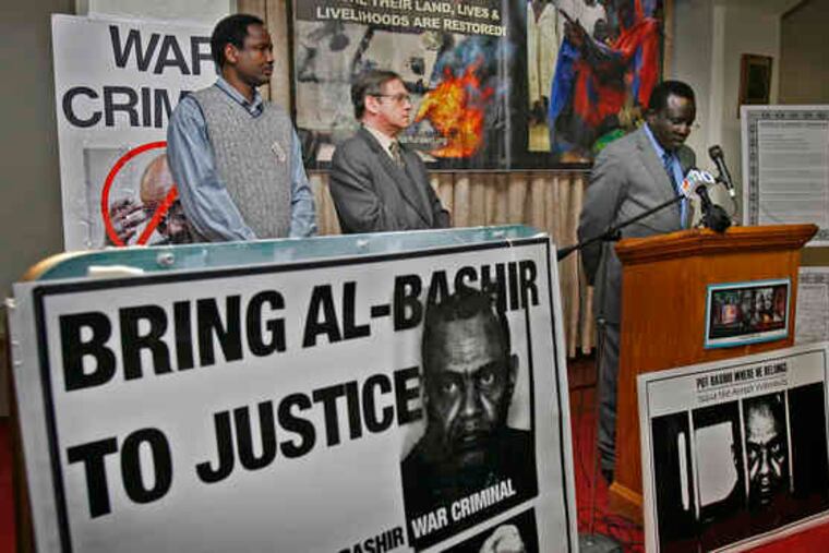 Ali B. Ali-Dinar (right), president of the Darfur Alert Coalition, speaks at a news conference. With him are City Controller Alan Butkovitz (center) and Darfuri native Ibrahim Hamid.