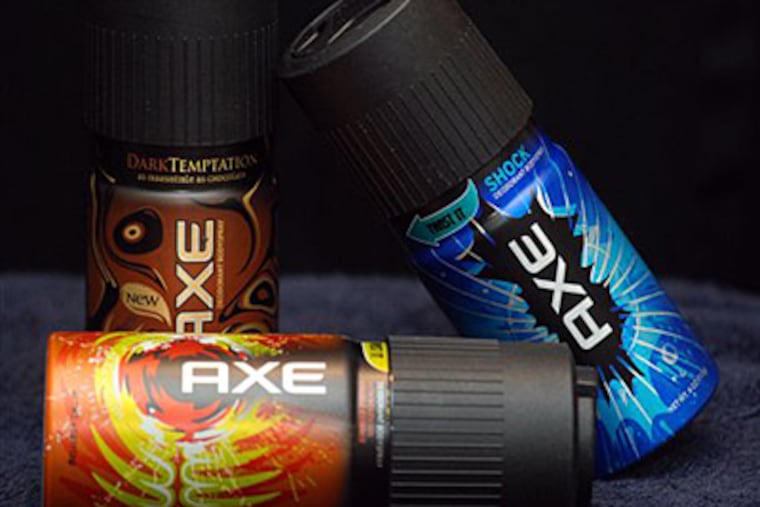 Cans of Axe deodorant body spray: Dark Temptation, background left, Shock, background right, and Fever. Axe targets a line of deodorants, body sprays and other products to young men ages 18-24, but the brand is also popular with teenage boys. (AP Photo/Shoun Hill)