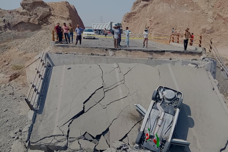 An overturned car sits on a section of a destroyed bridge after a strike in Hormozgan province, southern Iran, Saturday, July 18, 2026.