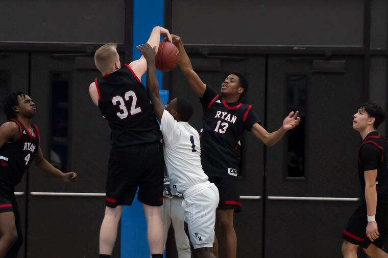 Archbishop Ryan's Christian Isopi (No. 32) and Jalen Snead (No. 13) block a shot by Penn Wood's Shamir Baynes during the first round of the PIAA Class 5A State Boy's Basketball Tournament at Norristown Area High School. Archbishop Ryan won, 62-50.