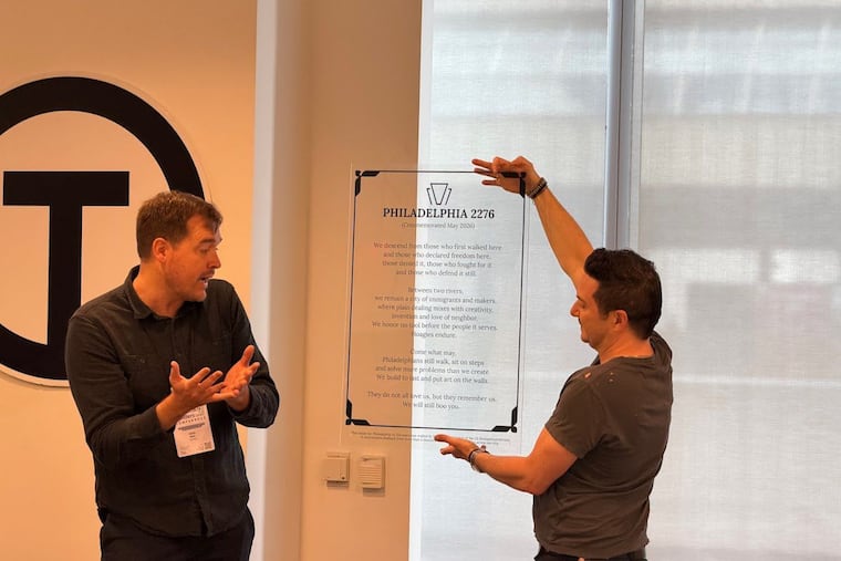 Christopher Wink (left) first publicly reads the vision statement for Philadelphia in 2276, at the Technical.ly Builders Conference on May 8, during Philly Tech Week. The plaque is held by Sean Martorana, who is creating a mural inspired by the vision statement with Mural Arts Philadelphia.