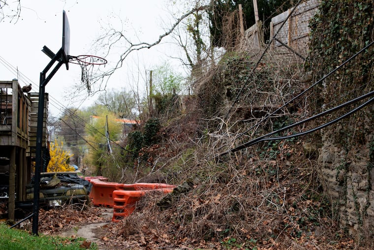 The fallen retaining wall behind the homes on the 300 Block of Glen Echo Road on Thursday, April 2, 2026 in Philadelphia.