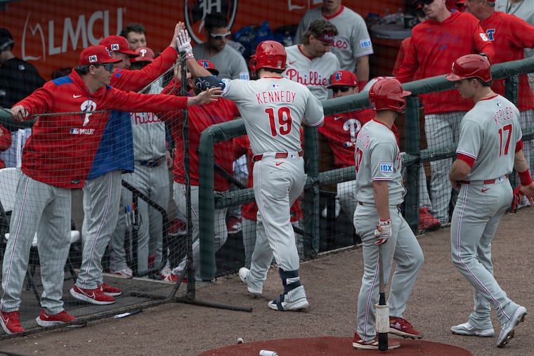 Phillies’ Buddy Kennedy is congratulated after a two-run homer in the fifth inning against the Detroit Tigers on Feb 22.