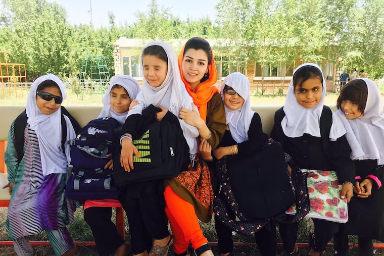 Yasameen Mohammadi, part of the new generation of educated Afghan women, meets with students from the Kabul School for the Blind, where she set up a braille library.