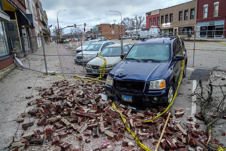 Bricks litter the sidewalk at the scene where the roof of the Apollo Theatre collapsed during a tornado Saturday in Belvidere, Ill. Possible severe weather was in the Philly forecast for later Saturday.