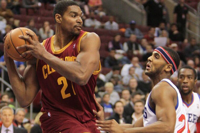 Andrew Bynum grabs a rebound from Tim Ohlbrecht. (Steven M. Falk/Staff Photographer)
