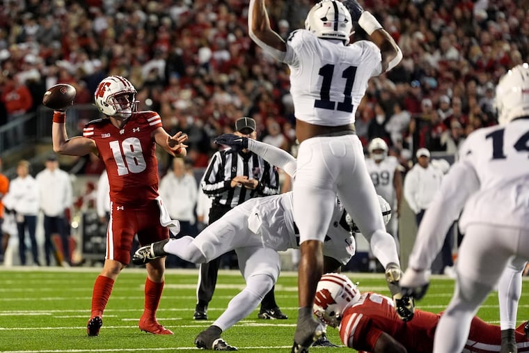 Wisconsin's Braedyn Locke passes during the first half Saturday as Penn State's Abdul Carter (11) moves in.