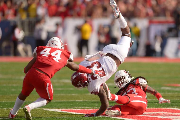 Temple's Zaire Williams is upended by Houston's Trevon Stewart in the second half of the AAC title game.