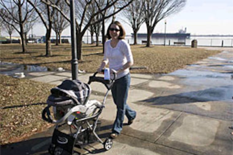 Liz Batter grew up in Marcus Hook and returns often - recently to take her infant daughter, Nellie, to Market Square Memorial Park on the borough's prime riverfront. (Ed HIlle / Staff Photographer)