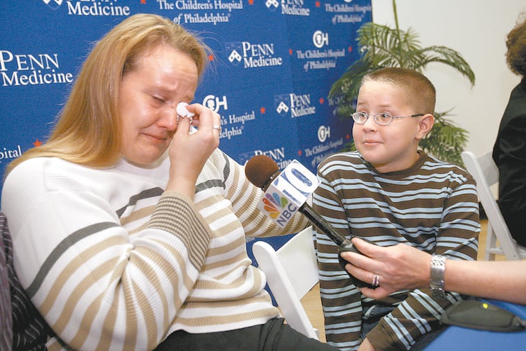 In a 2009 photograph, Nancy Haas of Hadley, NY wipes away tears as she talks about the dramatic improvement in the vision of her son, Corey Haas, 9, since receiving the gene therapy.