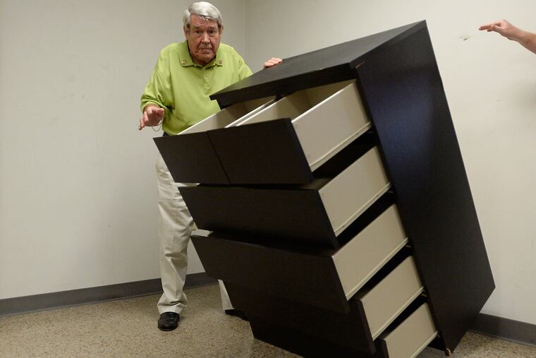 Bobby Puett, president of Diversified Testing Labs, watches as the Ikea Malm six drawer dresser falls over during a tip over test at Diversified Testing Labs in Burlington, North Carolina, September 17, 2015. The dresser failed the test of staying upright when all six drawers were open and no additional weight was added. The dresser also failed the test when any one drawer was open and an additional fifty pound weight was added. Puett says the Ikea Malm dresser does not meet the standards of safety.