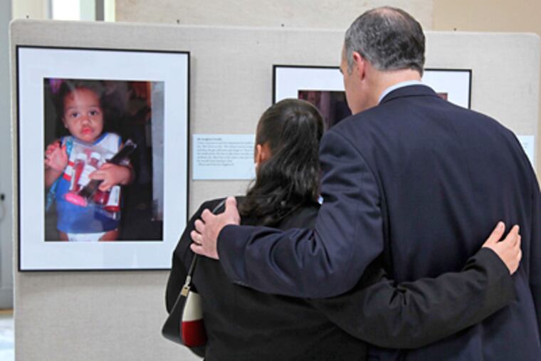 Tamika Haynesworth, a participant in “Witnesses to Hunger,” views her work with Sen. Robert P. Casey Jr., who sponsored the Capitol Hill showing. (Laurence Kesterson / Staff Photographer)