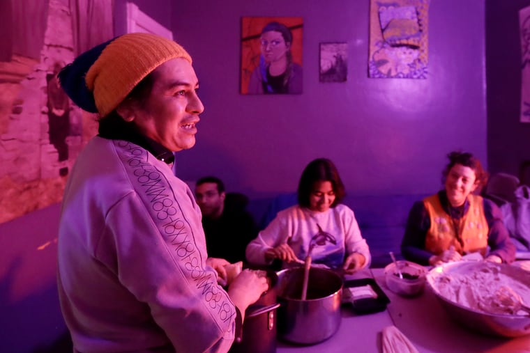 Brujo De La Mancha, Khristina Acosta (center), and Mandy Katz (right) make bean tamales in West Philadelphia.