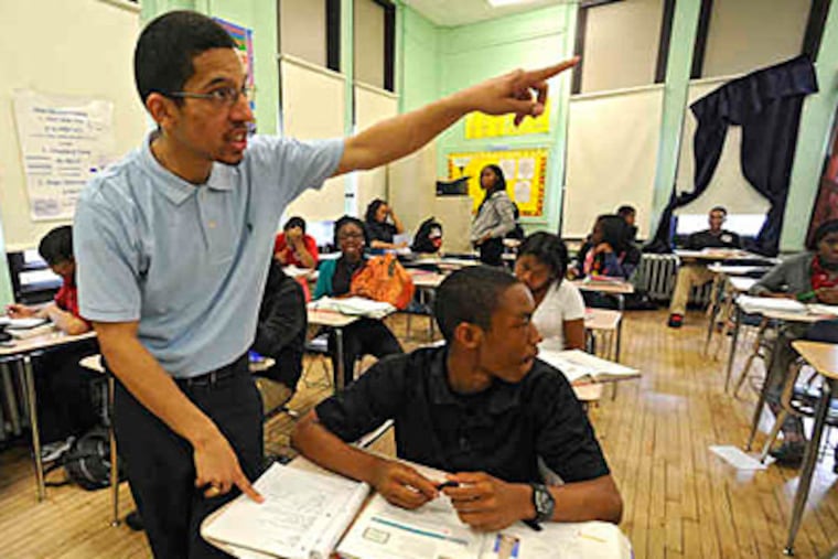 Kareem Demetrius Edwards explains an algebra problem for ninth grader Malik Hashim at Parkway West High in this May 2010 file photo. School officials said Wednesday that the district's classrooms have 70,000 empty seats. (Clem Murray/File)