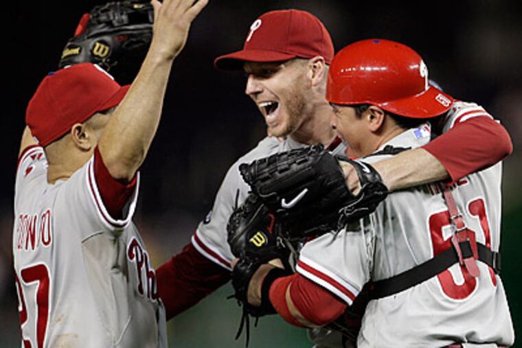 Placido Polanco, Roy Halladay and Carlos Ruiz celebrated after the final out of last night's win. (Yong Kim/Staff Photographer)