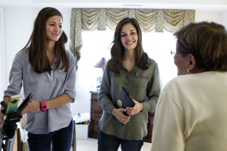 Lizzy Klump (left) and Emma Sauerwein (middle) say goodbye to Evergreens resident Grace Conway after interviewing and filming her. (Elizabeth Robertson / Staff Photographer)