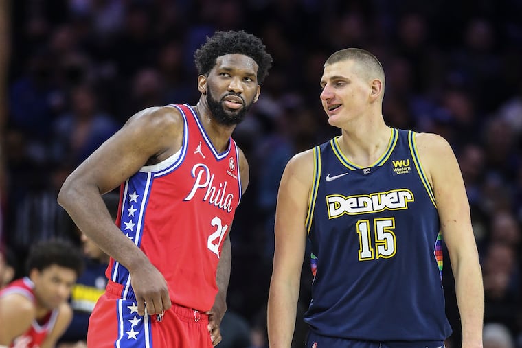 Joel Embiid chatting with the Nuggets' Nikola Jokic at the Wells Fargo Center on March 14.