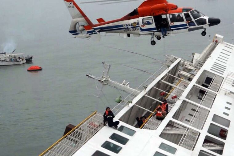 Passengers from the Sewol are rescued by a South Korean coast guard helicopter as the ferry sinks. A different video shows the captain being treated onshore after allegedly landing on one of the first rescue boats.