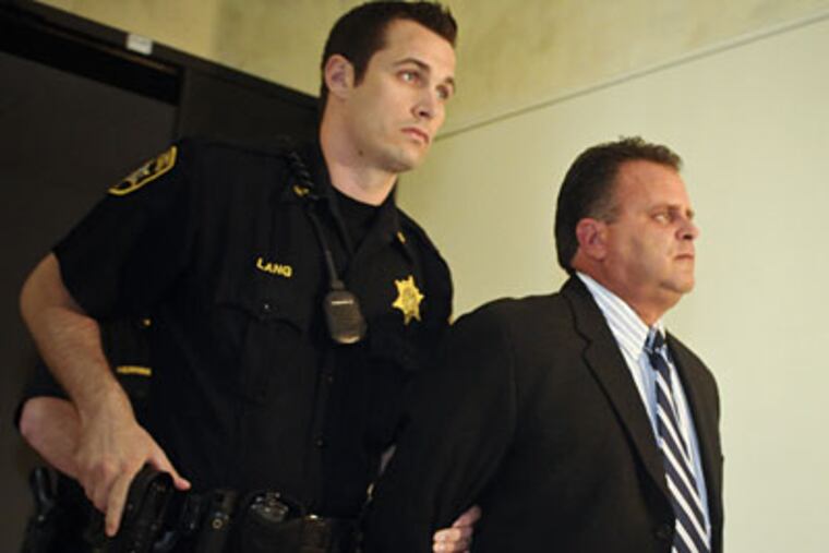 David Manilla, the Montgomery County lawyer who shot and killed a deer
hunter while illegally hunting near Quakertown last year, is lead from
court after receiving a 10-25 year sentence. (Ron Tarver / Staff
Photographer)